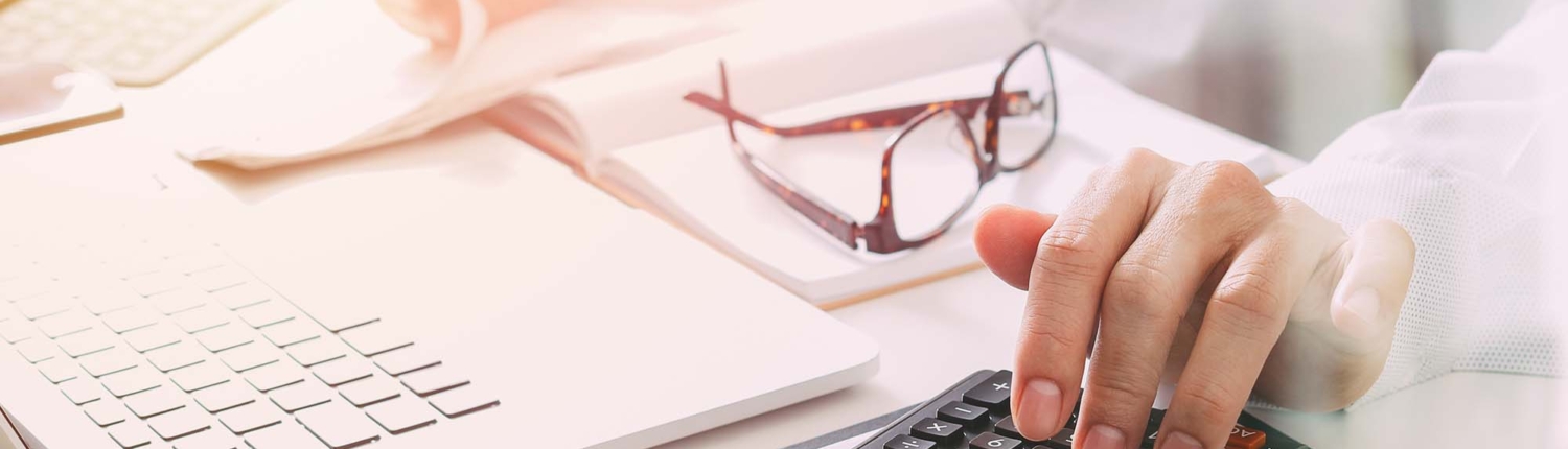 Healthcare costs and fees concept.Hand of smart doctor used a calculator for medical costs in modern hospital Healthcare costs and fees concept.Hand of smart doctor used a calculator for medical costs in modern hospital