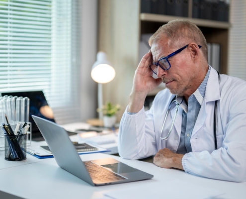 Concerned medical worker looking at computer